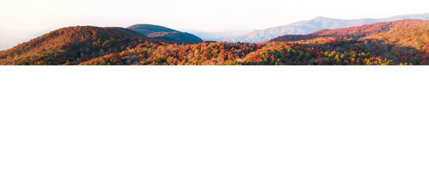 The background layer to a parallax header displaying some beautiful hills during the fall.